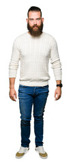 Young hipster man wearing winter sweater Relaxed with serious expression on face. Simple and natural looking at the camera.