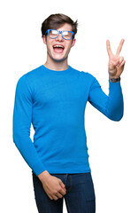 Fototapeta premium Young handsome man wearing blue glasses over isolated background smiling with happy face winking at the camera doing victory sign. Number two.