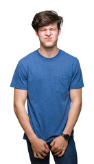 Young handsome man wearing blue t-shirt over isolated background puffing cheeks with funny face....