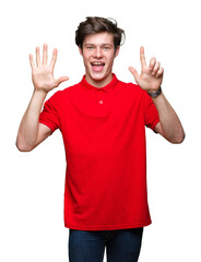 Fototapeta premium Young handsome man wearing red t-shirt over isolated background showing and pointing up with fingers number seven while smiling confident and happy.