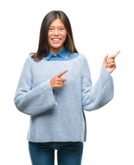 Young asian woman wearing winter sweater over isolated background smiling and looking at the camera...