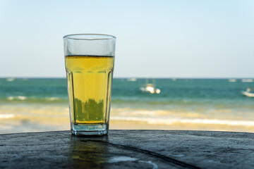 Photo of cold beer glass on the bar table at open-air cafe. copy space