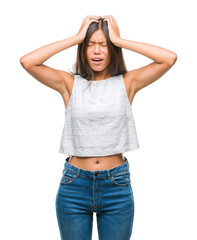 Fototapeta premium Young asian woman over isolated background suffering from headache desperate and stressed because pain and migraine. Hands on head.