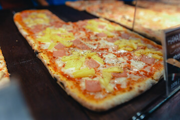 Pizza is sold in front of a shop on Walking Street