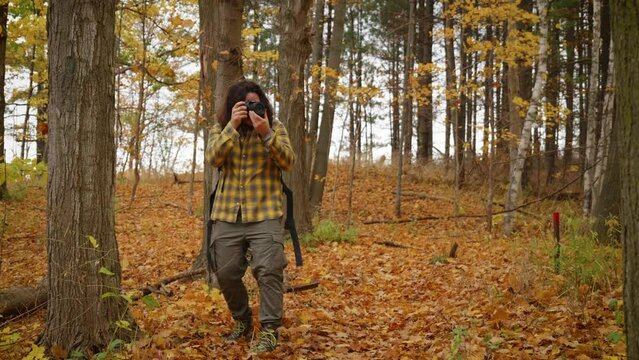 Photographer takes photos of forest during autumn.
