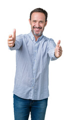 Naklejka premium Handsome middle age elegant senior man over isolated background looking at the camera smiling with open arms for hug. Cheerful expression embracing happiness.