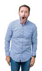 Handsome middle age elegant senior man over isolated background In shock face, looking skeptical...