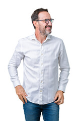 Fototapeta premium Handsome middle age elegant senior business man wearing glasses over isolated background looking away to side with smile on face, natural expression. Laughing confident.