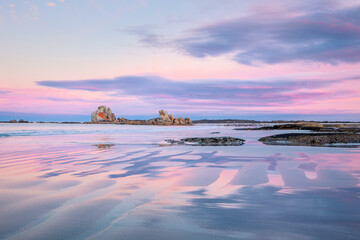 Picnic Rocks at sunrise with pink sky in Mt William National Park, Tasmania, Australia. 