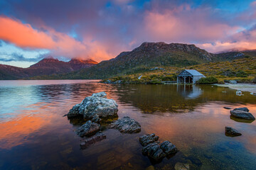 Sunset over Cradle Mountain looking across dove lake and a boat shed, Cradle Mountain National Park, Tasmania, Australia