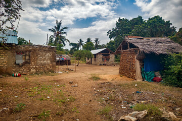 A poor African village in East Africa. Poor living conditions. Dusty street of poor african village