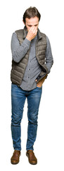 Fototapeta premium Middle age handsome man wearing winter vest tired rubbing nose and eyes feeling fatigue and headache. Stress and frustration concept.