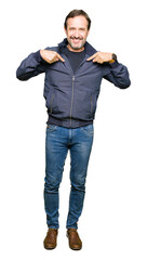 Fototapeta premium Middle age handsome man wearing a jacket looking confident with smile on face, pointing oneself with fingers proud and happy.
