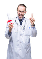 Middle age senior hoary doctor man holding degree certificate over isolated background surprised...