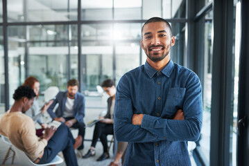 Man, smiling and excited in office portrait for new opportunity, internship or employment. Person, happy and colleagues meeting in background for collaboration, teamwork and partnership in workplace - obrazy, fototapety, plakaty