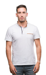 Handsome young casual man wearing white t-shirt with a confident expression on smart face thinking serious