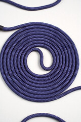 Purple rope twisted on a white background. Purple rope coil, close-up