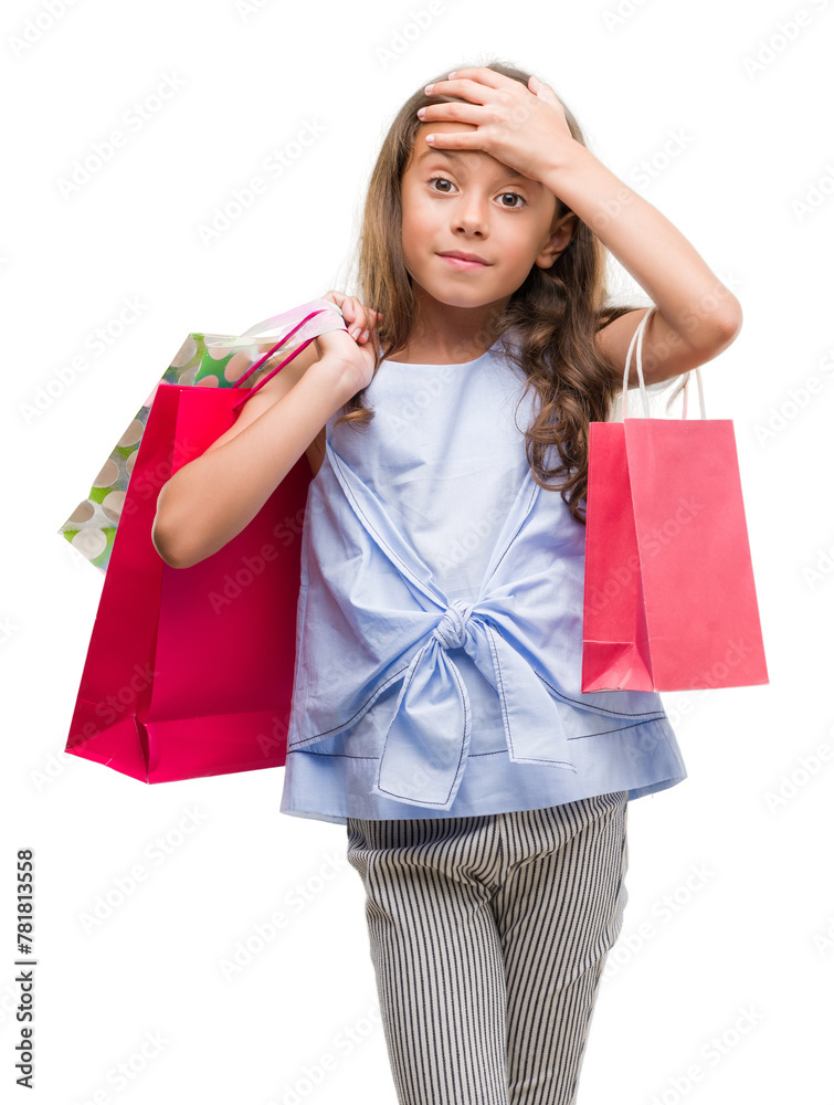 Poster brunette hispanic girl holding shopping bags stressed with hand on head, shocked with shame and surp