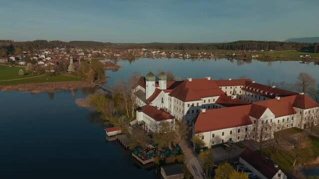 Kloster Seeon, in Bavaria. Catholic monastery church on lake island. Scenic alps mountains aerial in famous tourist vacation area. Political conference CSU