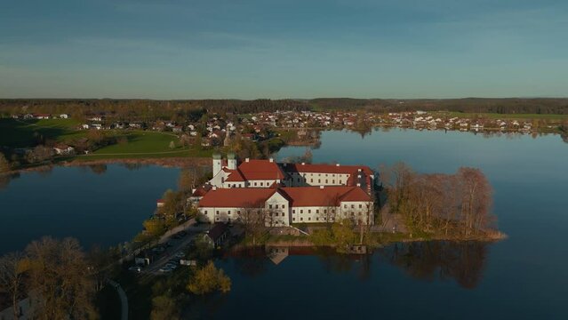 Kloster Seeon monastery. Catholic church on lake island in Bavaria. Scenic alps mountains aerial