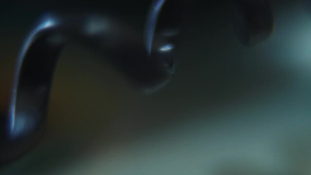 Macro shot of a telephone spiral wire, black old phone cable, SLIDE right smooth crane movement, 120 fps, slow motion, Full HD