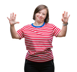 Young adult woman with down syndrome over isolated background showing and pointing up with fingers...