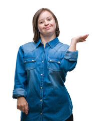 Young adult woman with down syndrome over isolated background smiling cheerful presenting and...