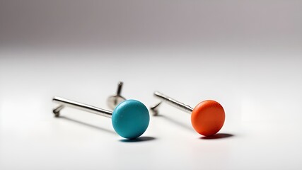 A close-up view of a pushpin, also known as a thumbtack, placed on a white background with a clipping path. The pin is isolated in the image, showcasing its details and texture. The composition allows