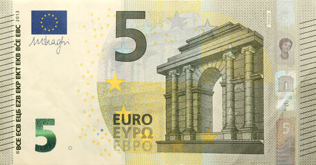 Fragment of one five euro money bill. Colorful details of European union currency banknote of five euro close up.
