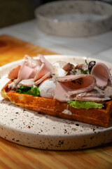 Waffles with dried meat and eggs Benedict