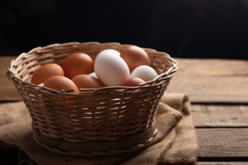 Basket of chicken eggs on a wooden table