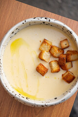 Tender cheese soup with olive oil and croutons