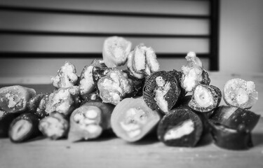 Black and white Macro close up of Various types of sliced peaces of Churchkhela with bank space...