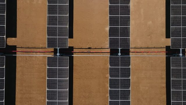 Aerial view of solar panel farm in the desert create a pattern of renewable energy power plant panels