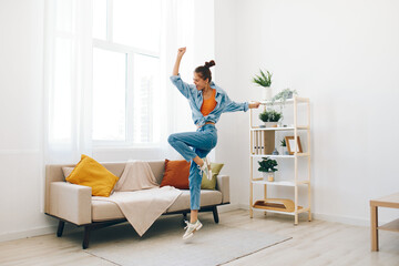Joyful Woman Jumping in her Home – A Carefree Concept of Happiness and Relaxation