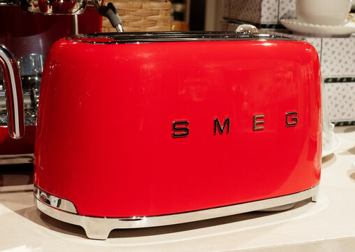 Smeg red toaster with silver chrome plating, small appliances with Italian design to decorate the kitchen.Milan - Italy,08 April 2024