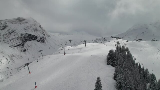 Lifts and skiers at Portes du Soleil ski resort in the French and Swiss Alps, 4K