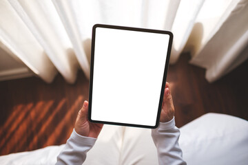 Top view mockup image of a woman holding digital tablet with blank desktop screen at home - 781847974