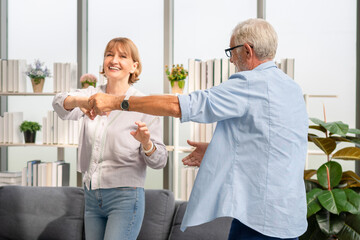Happy senior couple dancing in living room, Senior couple spending time together in the living...