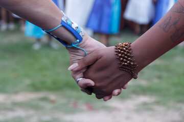 Two women from Maracatu, a Brazilian cultural and religious artistic activity, holding hands in a...