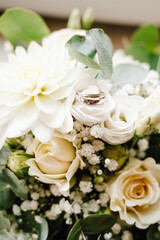 Silver wedding ring in bright flower bouquet