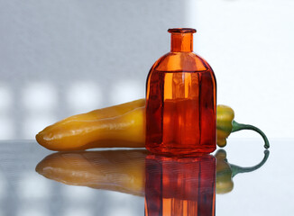 Glass bottle and  sweet long pepper