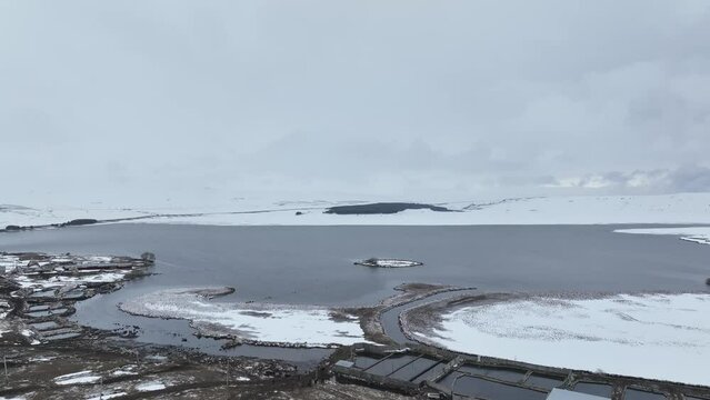 Aerial view of Paravani river floating in Saghamo Lake. Samtskhe-Javakheti, Georgia