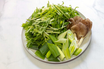 Mushroom and vegetables on white plate. 