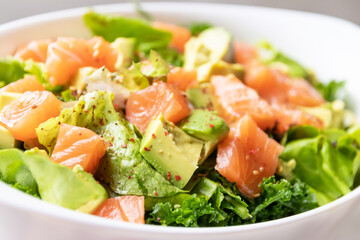 Green salad, avocado with toro salmon. Healthy and balanced menu.