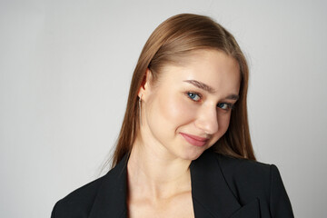 Obraz premium Young Woman in Black Jacket Posing to Camera against gray background