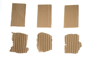 Set of six pieces of corrugated cardboard with torn edges isolated on white background.six