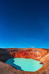 Cover page with Icelandic landscape of colorful volcanic caldera Askja, Viti crater lake in volcanic desert in Highlands, with red, turquoise volcano soil and blue gradient sky, Iceland