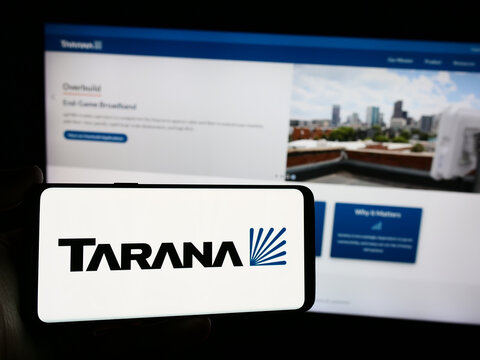 Stuttgart, Germany - 03-28-2024: Person holding smartphone with logo of US telecommunications company Tarana Wireless Inc. in front of website. Focus on phone display.