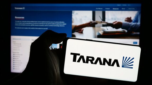 Stuttgart, Germany - 03-28-2024: Person holding mobile phone with logo of American telecommunications company Tarana Wireless Inc. in front of web page. Focus on phone display.